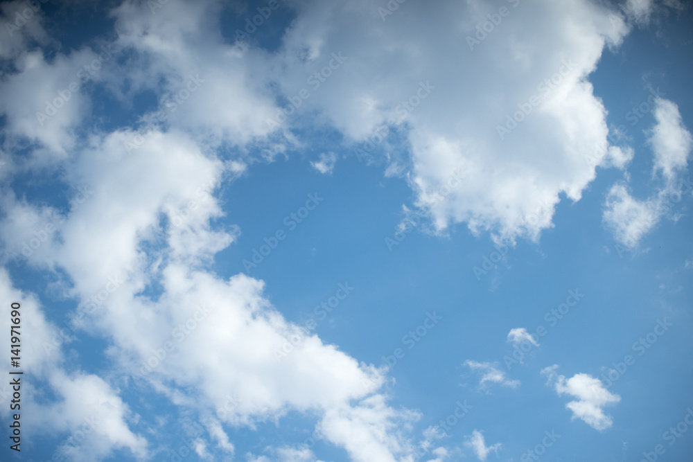 Obraz premium White heap clouds in the blue sky at the summer day.