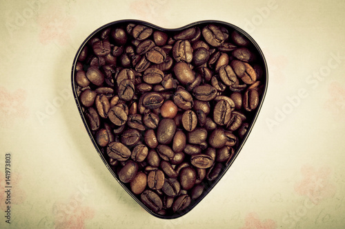 shape of a heart filled with coffee beans over romantic backround in retro vintage style  © starblue