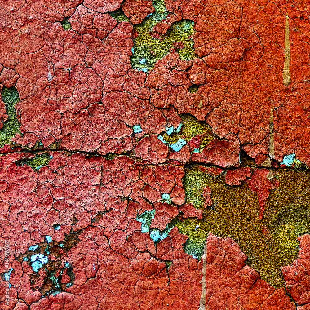 Old wall covered with red paint cracked