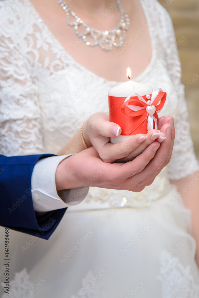 The bride and groom holding a candle The bride and groom holding a candle
