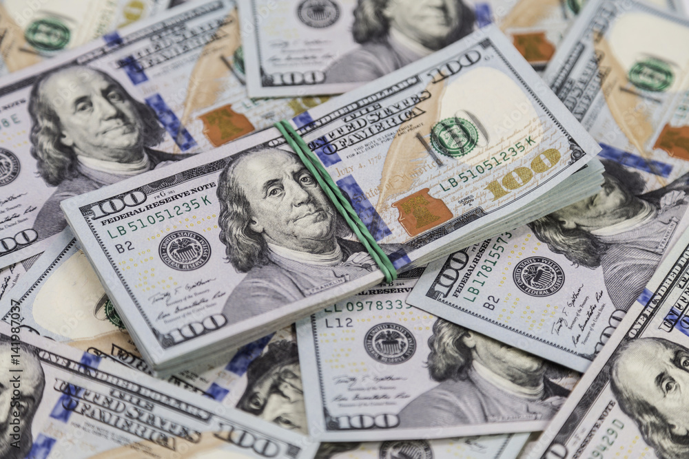 Background of dollar bills and a bundle of dollars on top Background of dollar bills and a bundle of dollars on top