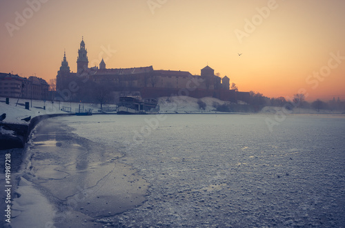 Krakow, Poland, Wawel Castle and Wawel cathedral in the winter over frozen Vistula river in the morning