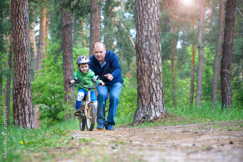Little kid boy of 3 years and his father in autumn forest with a Little kid boy of 3 years and his father in autumn forest with a