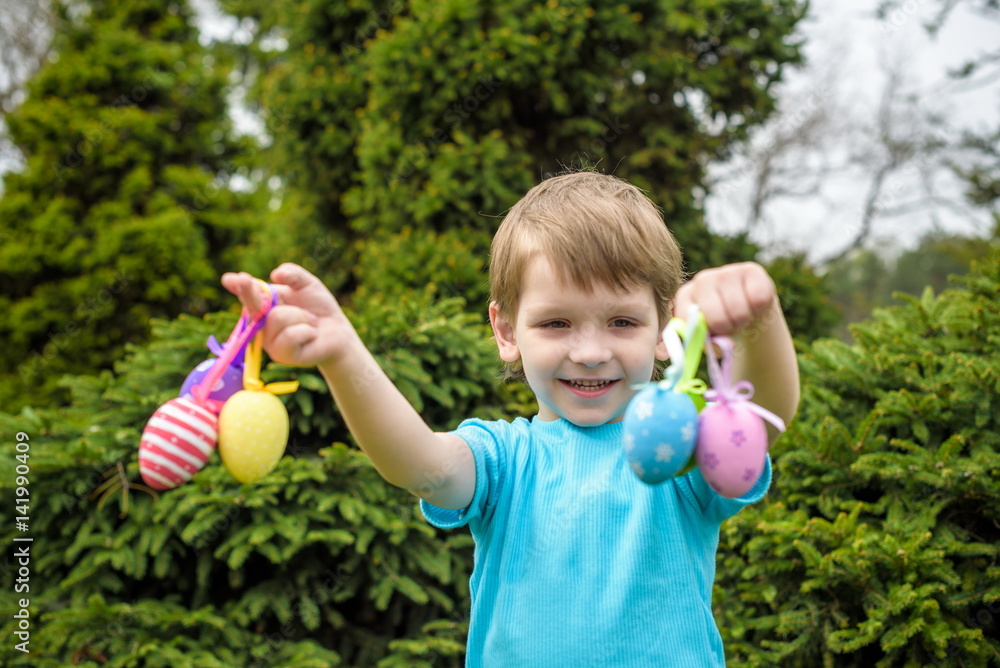 Different color Easter Eggs in a child's hands- egg hunt Different color Easter Eggs in a child's hands- egg hunt