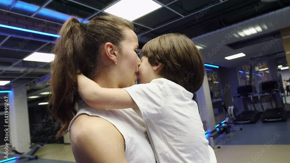 Mother and son posing on camera at gym Mother and son posing on camera at gym