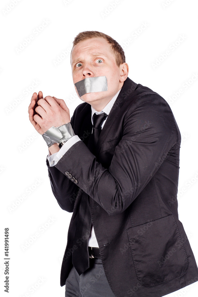 businessman with adhesive tape on his mouth and hands. . businessman with adhesive tape on his mouth and hands. .