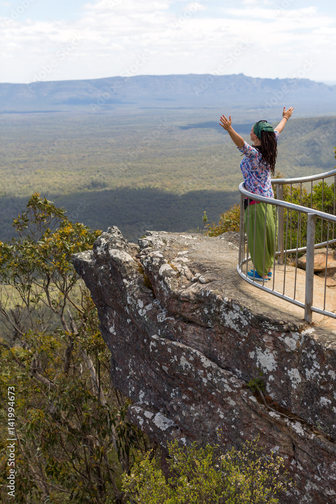Naklejka premium Woman enjoying her freedom with open arms, Australia 