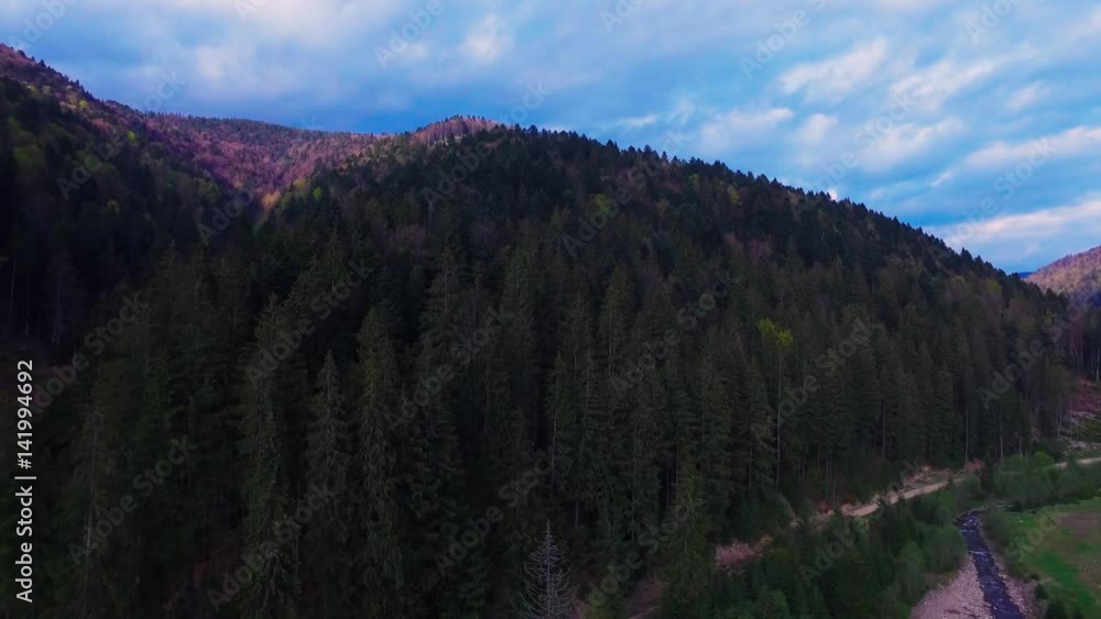 Beautiful above view of mountains. Aerial view. View of mountain forest. Blue sky with clouds. Flying over the green fields. Beautiful above view of mountains. Aerial view. View of mountain forest. Blue sky with clouds. Flying over the green fields.