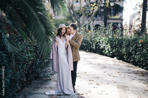 Young elegant fashion couple in park