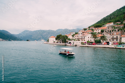 The old town of Perast on the shore of Kotor Bay, Montenegro. The ancient architecture of the Adriatic and the Balkans. Boats and yachts on the dock. © Nadtochiy