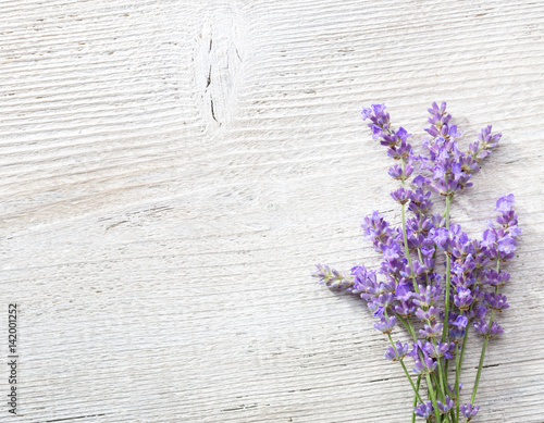 Few sprigs of lavender on an old wooden background