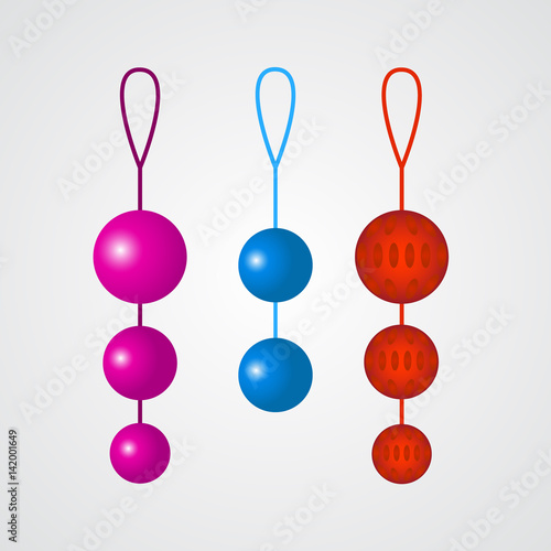 Set of colorful vaginal balls on a grey background.