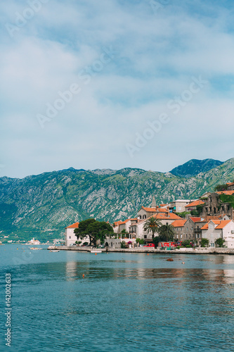 Fototapeta Naklejka Na Ścianę i Meble -  The old town of Perast on the shore of Kotor Bay, Montenegro. The ancient architecture of the Adriatic and the Balkans. Fishermen's cities of Europe.