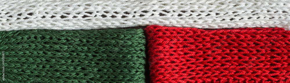 Knitted fragments of the flag colors: red, white, green