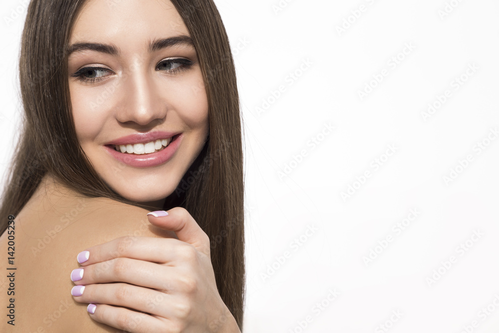 Smiling woman touching her shoulder Smiling woman touching her shoulder