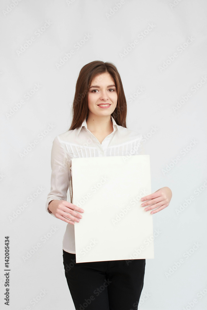 Teenager girl hold white blank paper. Young smiling woman show blank card. Teenager girl hold white blank paper. Young smiling woman show blank card.