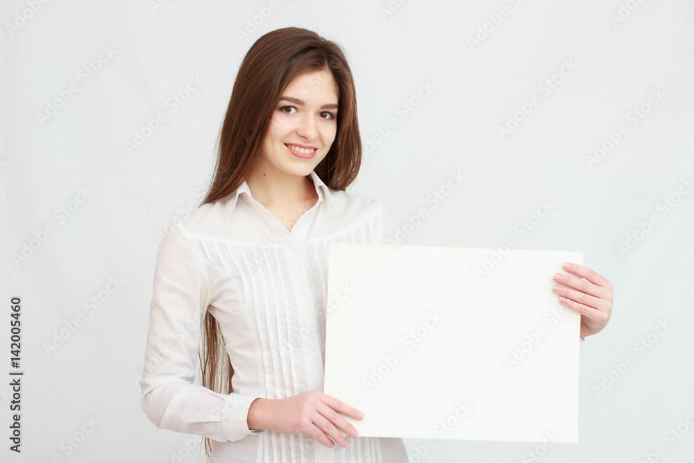 Teenager girl hold white blank paper. Young smiling woman show blank card. Teenager girl hold white blank paper. Young smiling woman show blank card.