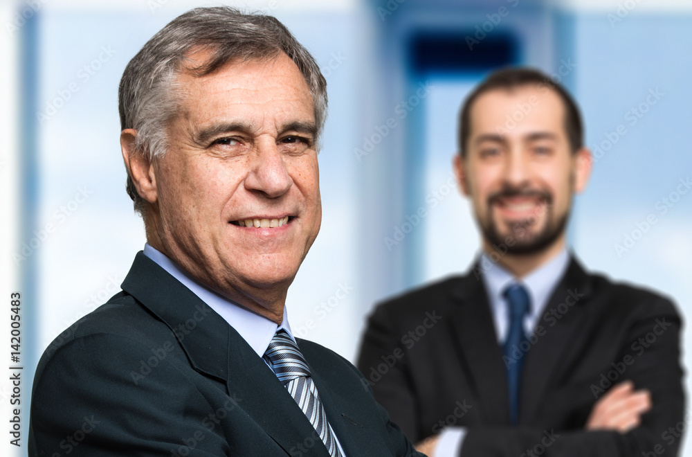 Smiling businessman in front of his boss Smiling businessman in front of his boss