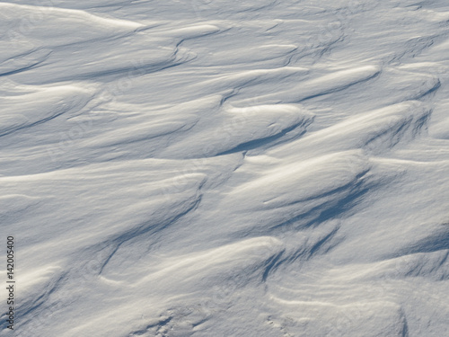 Snow like waves frozen from the winter winds.
