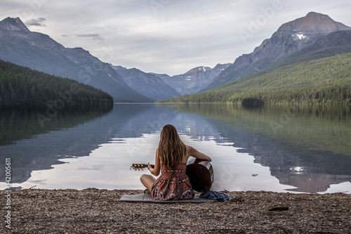 Woman on Alpine Lake Playing Guitar photo