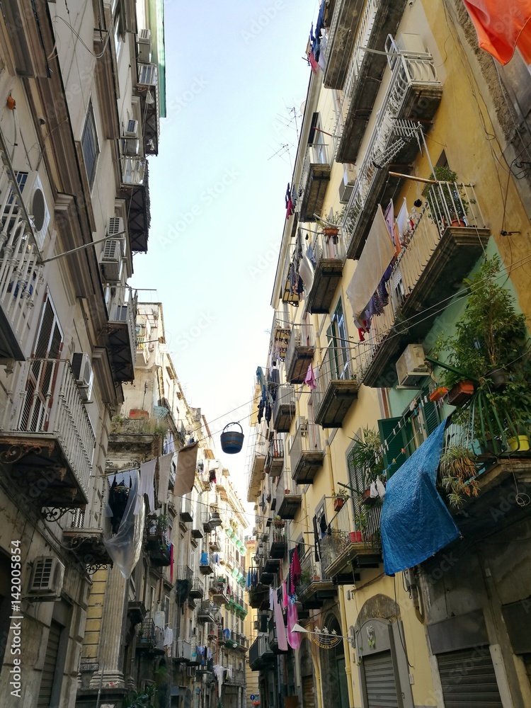 NAPLES, ITALY - JANUARY 28, 2017 : street view of old city center of Naples with clothes hanging in the street.