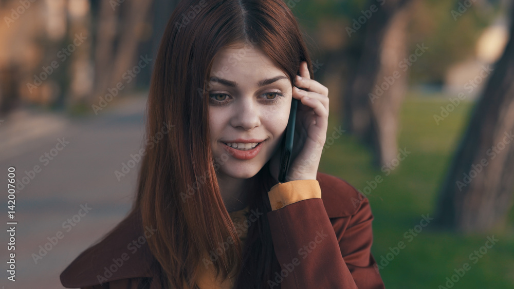 surprised woman walking down the street and talking on the phone surprised woman walking down the street and talking on the phone