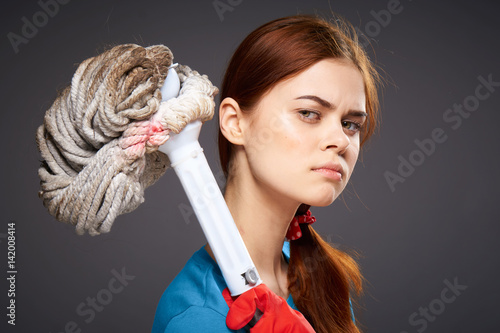 confident woman holding a mop in her hand