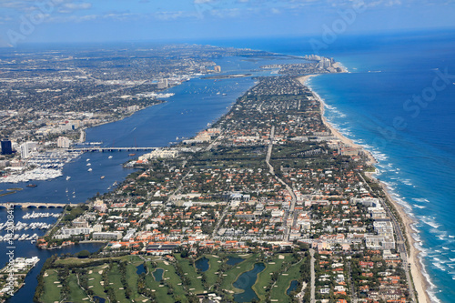 Aerial view of beautiful Palm Beach and Singer Island, Florida, along with the Atlantic Ocean, and the red roof tops of Worth Avenue. photo