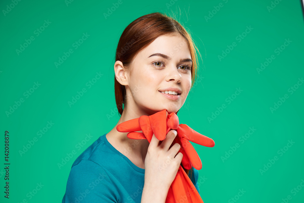 working gloves, a woman in a blue T-shirt on a green background working gloves, a woman in a blue T-shirt on a green background