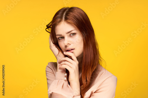 yellow background and attractive woman in a light shirt