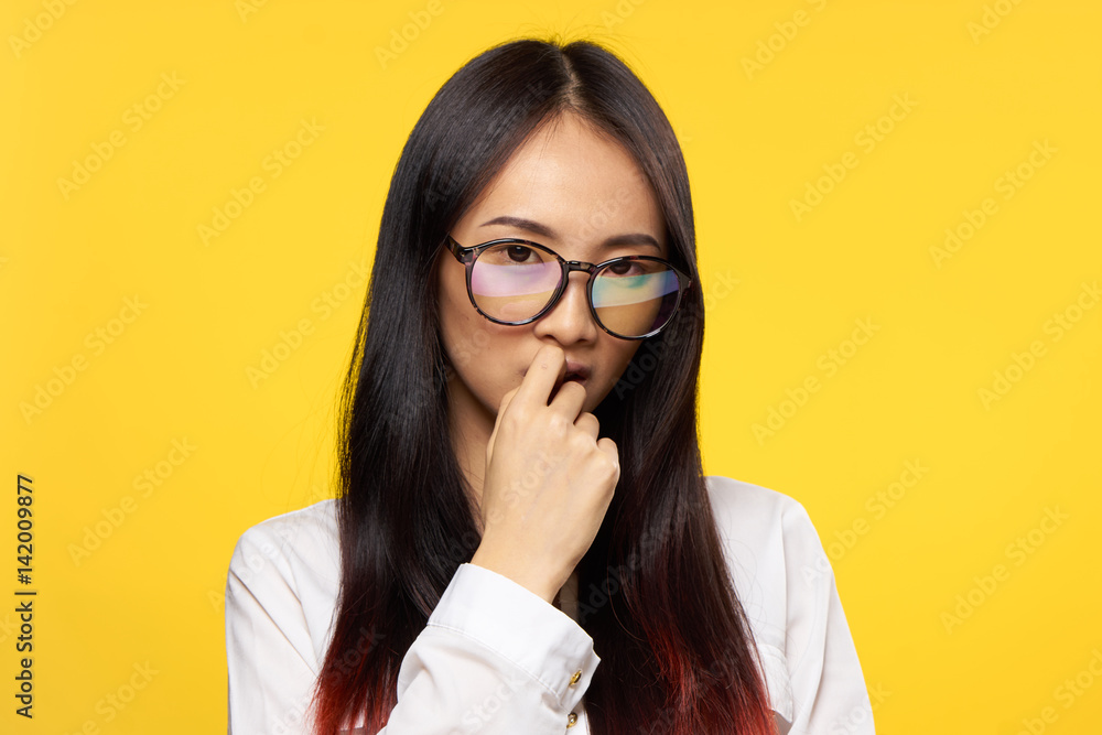 puzzled woman with glasses looks at the camera puzzled woman with glasses looks at the camera