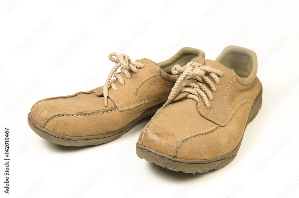 Brown leather men's shoes with wooden shoe stretchers on the side Brown leather men's shoes with wooden shoe stretchers on the side
