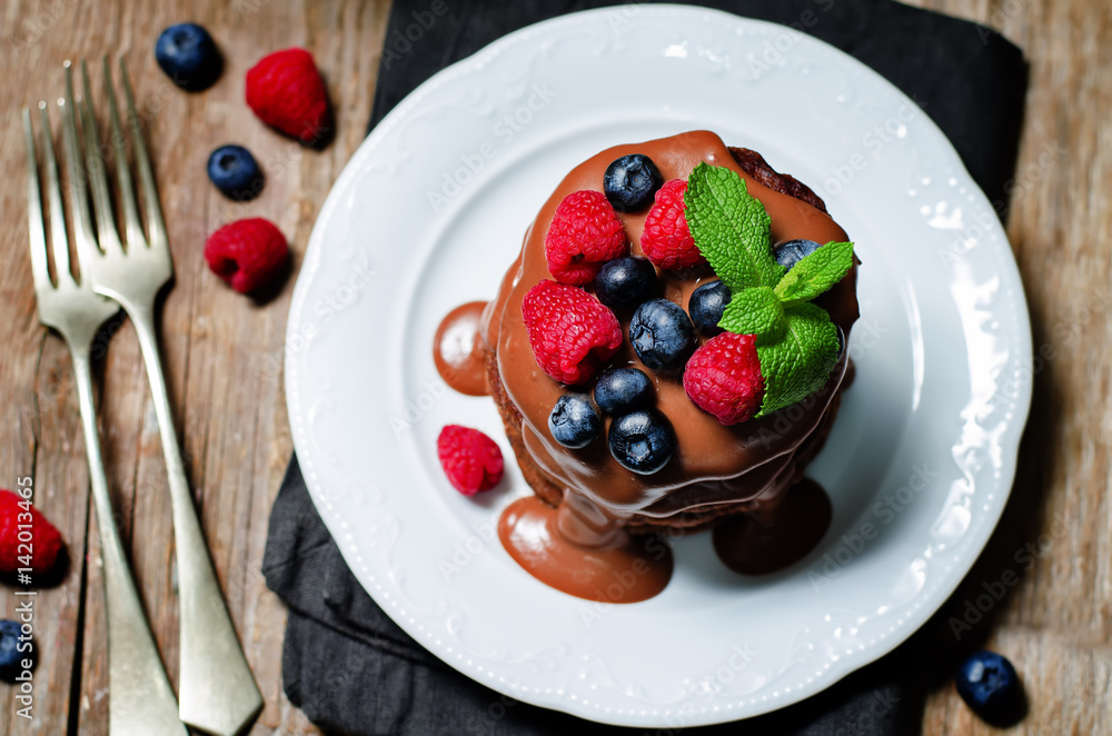chocolate pancake with blueberries, raspberies and chocolate sauce chocolate pancake with blueberries, raspberies and chocolate sauce