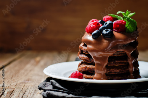 chocolate pancake with blueberries, raspberies and chocolate sauce