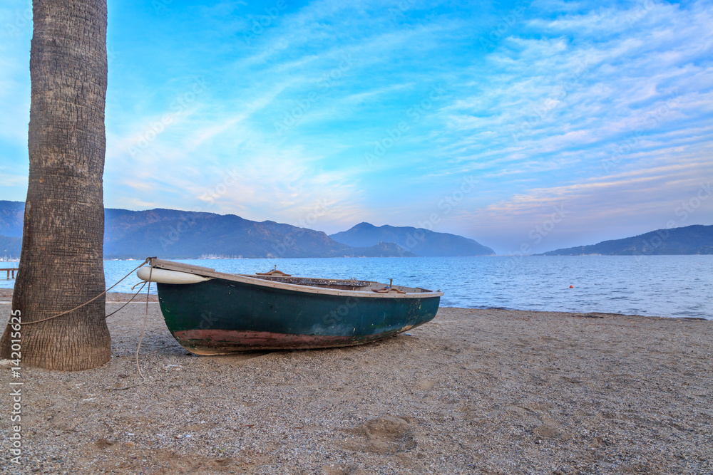 Green boat on sands of Marmaris beach in Marmaris, Turkey Green boat on sands of Marmaris beach in Marmaris, Turkey