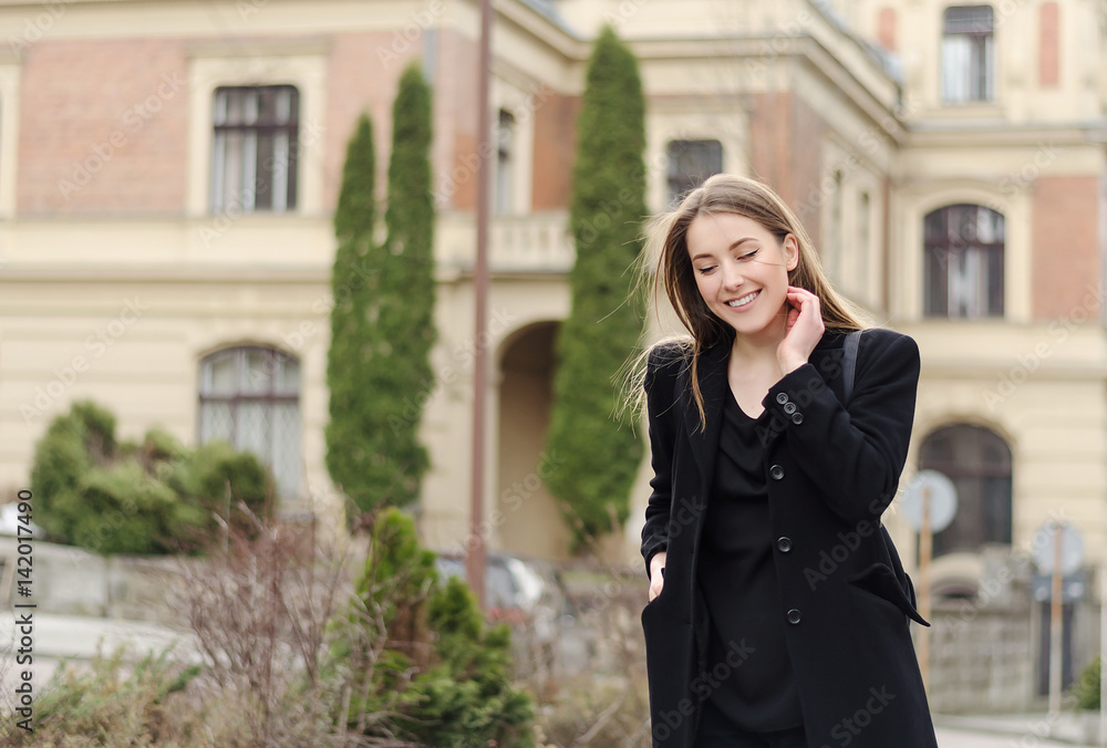 Fototapeta premium Portrait of walking smiling girl student in spring