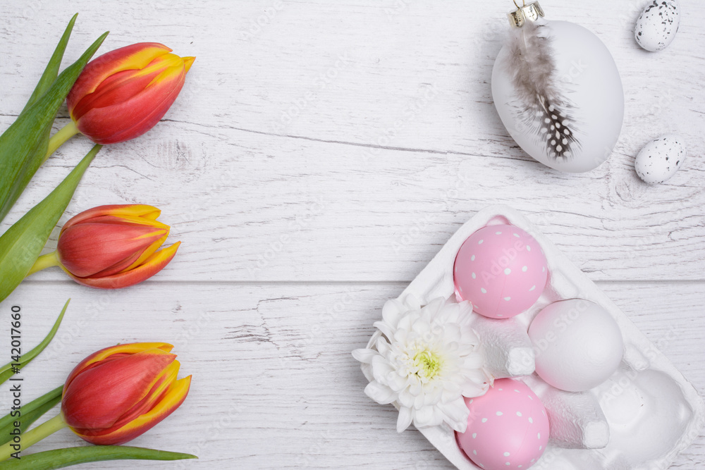 Easter eggs and tulips over wooden background. Easter eggs and tulips over wooden background.
