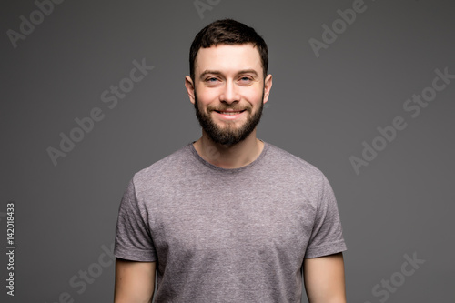 Portrait of a smart serious young man in casual clothes standing