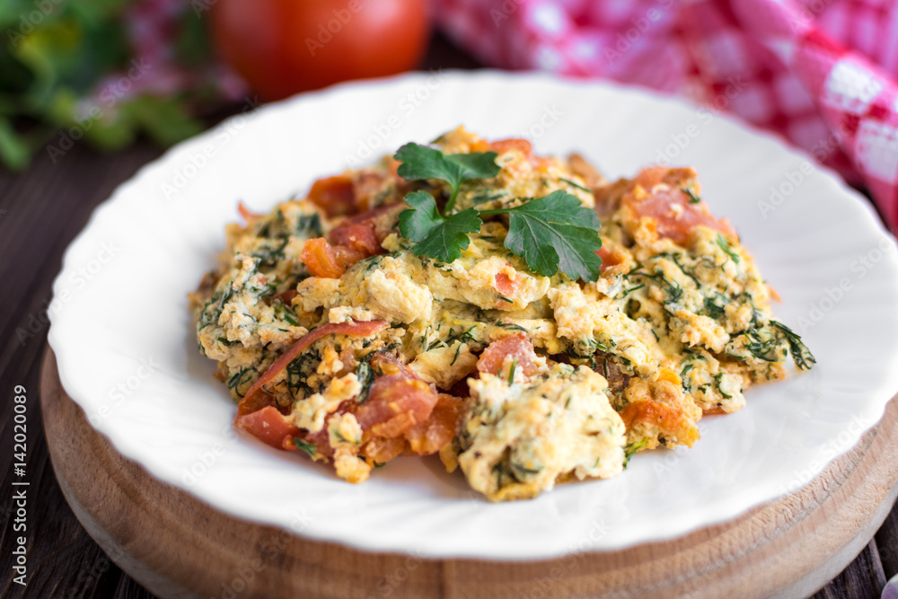 Fried eggs with tomato on dark wooden table Fried eggs with tomato on dark wooden table