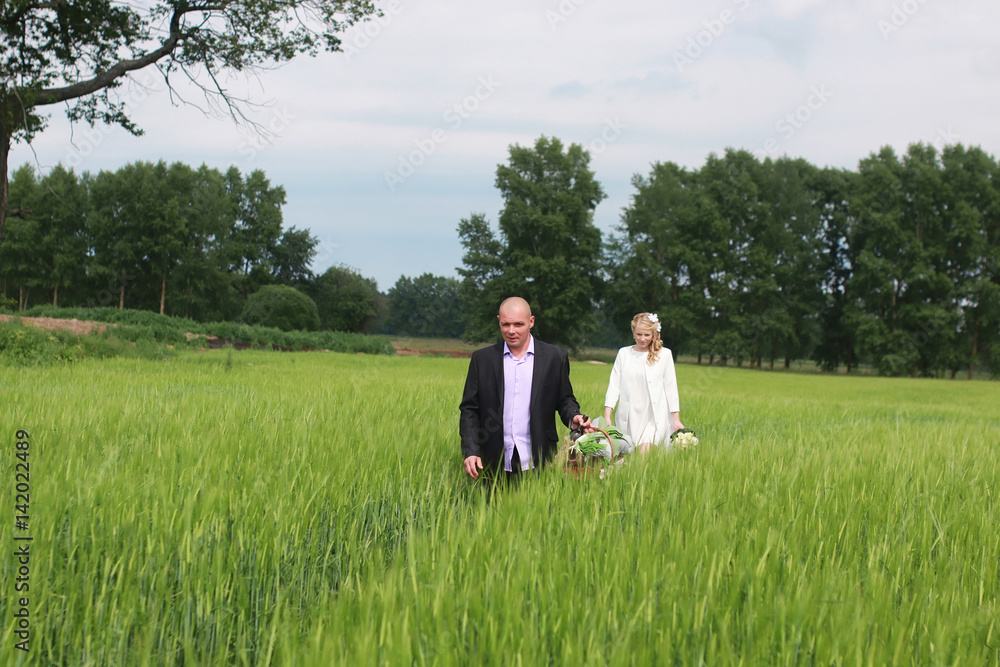 Couple lovers walking in field in summer day Couple lovers walking in field in summer day