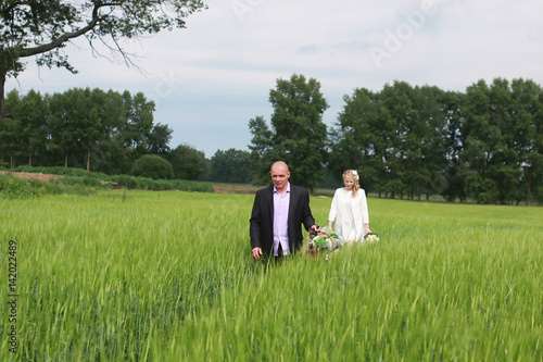 Couple lovers walking in field in summer day © alexkich