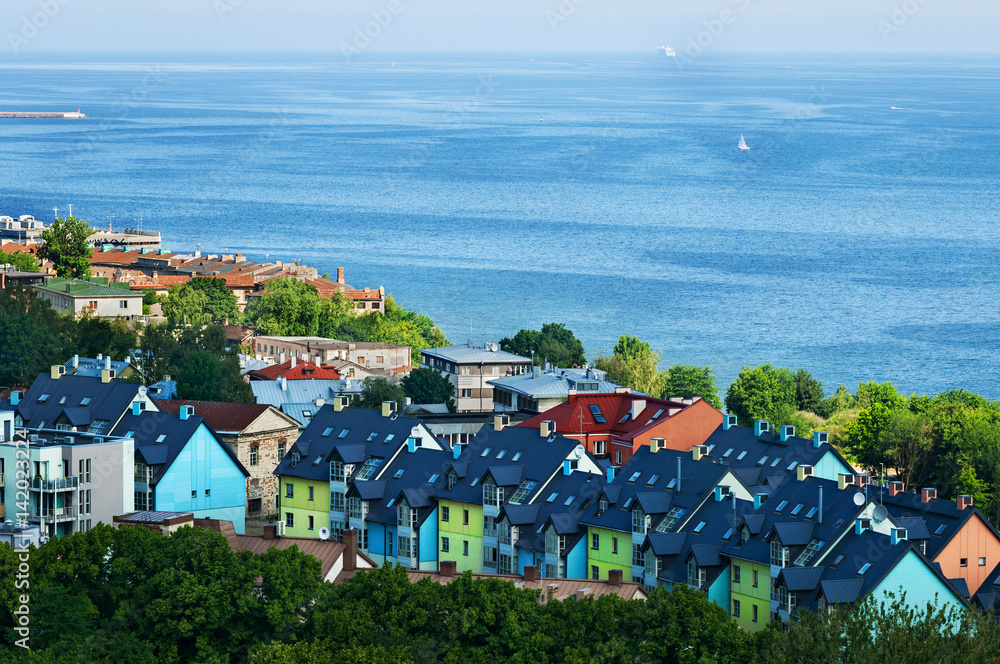 A lots of little colorful houses near the sea with blue sea and skyline