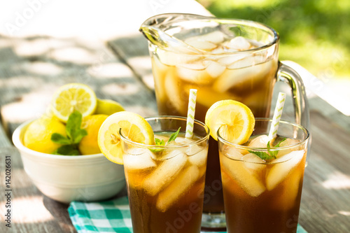 Iced Tea With Lemon and Mint On Picnic Table