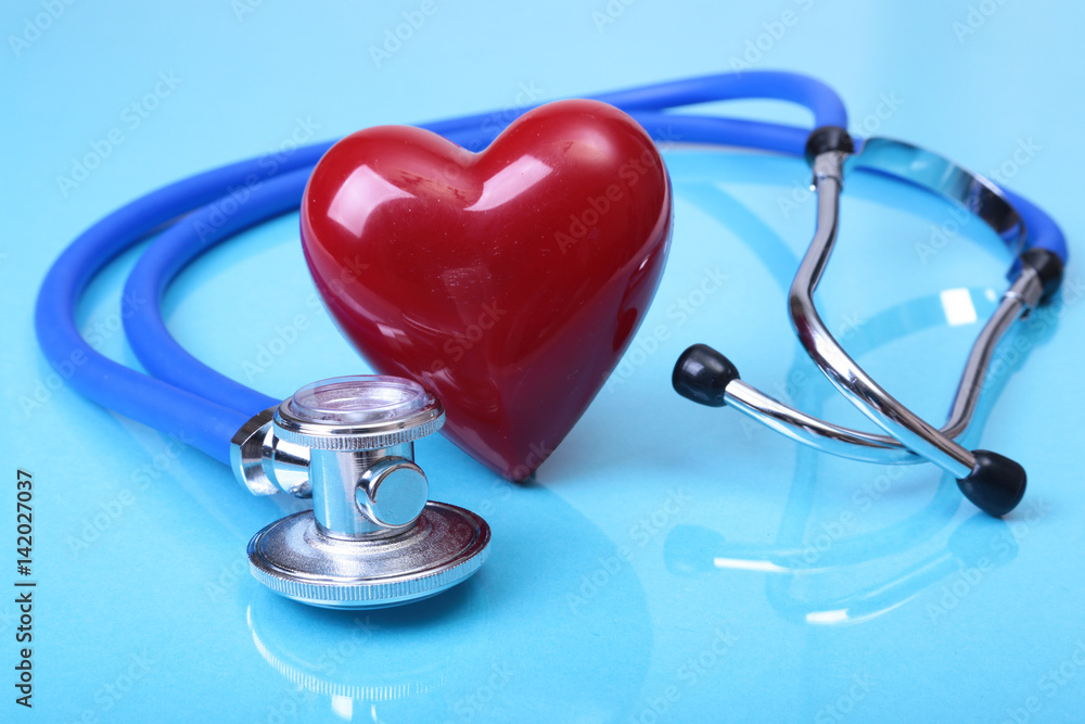 Medical stethoscope and red heart isolated on blue mirror background. you can place your text. Medical stethoscope and red heart isolated on blue mirror background. you can place your text.