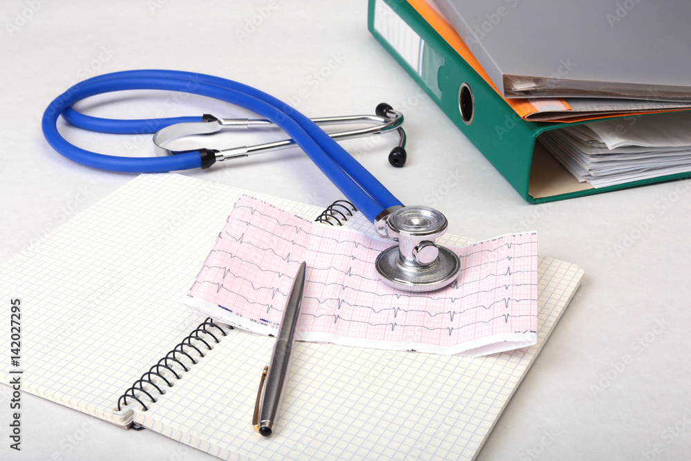 Folder file, stethoscope and RX prescription on the desk. blurred background. Folder file, stethoscope and RX prescription on the desk. blurred background.
