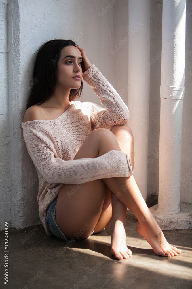 Sexy beautiful woman in jeans shorts sitting on the floor Stock Photo |  Adobe Stock