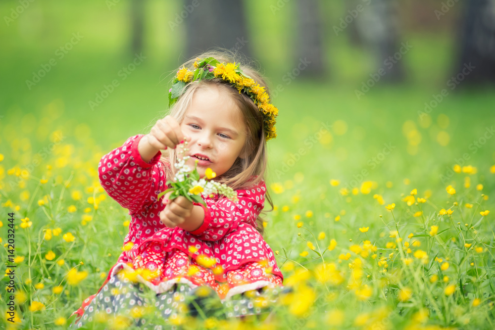 Portrait of happy little girl on a flower field Portrait of happy little girl on a flower field