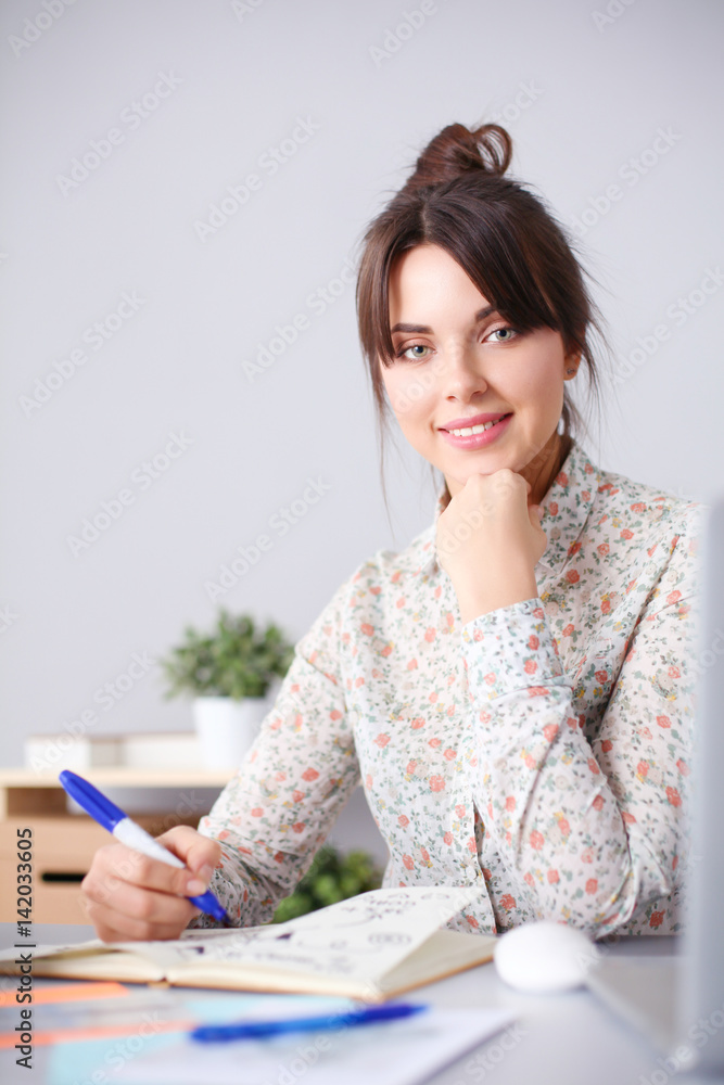 Portrait of young woman sitting at desk Portrait of young woman sitting at desk