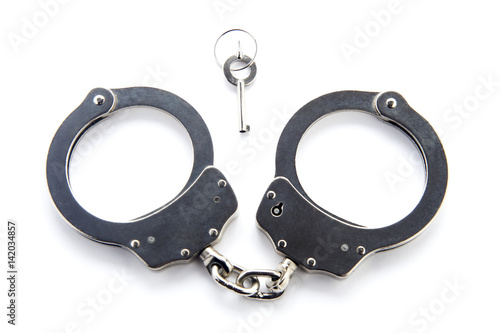 Handcuffs and key isolated on white background