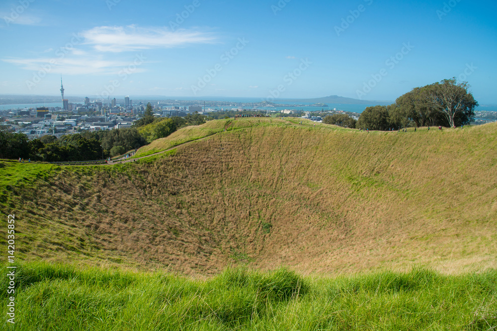 Mount Eden the old volcano in town with the skyline view of Auckland the biggest city in New Zealand.